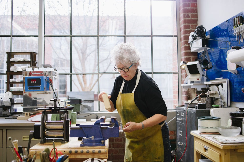 Ältere Frau arbeitet in einer Werkstatt
